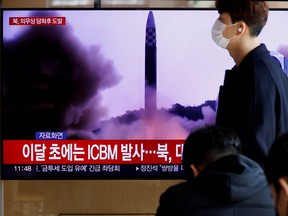 A man walks past a TV broadcasting a news report, on North Korea firing a ballistic missile off its east coast, in Seoul, South Korea, Nov. 17, 2022.