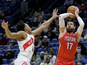 New Orleans Pelicans center Jonas Valanciunas shoots against Toronto Raptors forward Scottie Barnes during the second half of an NBA basketball game in New Orleans, Monday, Feb. 14, 2022.