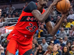 Toronto Raptors forward Chris Boucher (25) shoots the ball while Indiana Pacers forward Aaron Nesmith (23) defends in the second quarter at Gainbridge Fieldhouse.