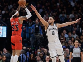 Gary Trent Jr. #33 of the Toronto Raptors puts up a shot over Ben Simmons #10 of the Brooklyn Nets.