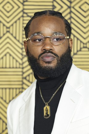 Director Ryan Coogler wears a necklace inspired by the late actor Chadwick Boseman as he arrives at the premiere of the movie 'Black Panther: Wakanda Forever' in London, Thursday 3 November 2022 .