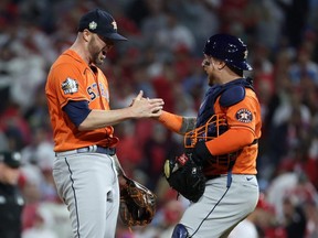 Astros pitcher Ryan Pressly, left, and catcher Christian Vazquez celebrate a combined no-hitter to defeat the Phillies 5-0 in Game 4 of the World Series at Citizens Bank Park in Philadelphia, Wednesday, Nov. 2, 2022.