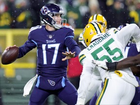 Ryan Tannehill, left,  of the Tennessee Titans looks to throw a pass against the Green Bay Packers during the first quarter in the game at Lambeau Field on Nov. 17, 2022 in Green Bay, Wis.