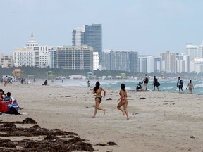 Beachgoers are shown as Tropical Storm Nicole approaches the state in Miami Beach, Florida November 8, 2022.