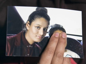 In this file photo taken on February 22, 2015 Renu, eldest sister of missing British girl Shamima Begum, holds a picture of her sister while being interviewed by the media in central London, on February 22, 2015.