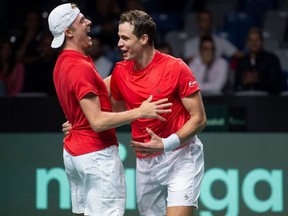 Canada's Denis Shapovalov (left) celebrates with Vasek Pospisil after winning the men's doubles quarterfinal match against Germany during the Davis Cup tennis tournament at the Martin Carpena sports hall, in Malaga, Spain, Thursday, Nov. 24, 2022.