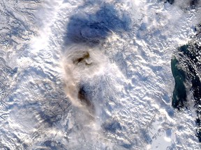 This image obtained from NASA, shows an ash plume from the Shiveluch volcano, in Kamchatka Peninsula, in eastern Russia.