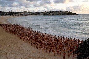 Participants pose nude at sunrise on Sydney's Bondi Beach for U.S. art photographer Spencer Tunick, to raise awareness for skin cancer, Saturday, Nov. 26, 2022.