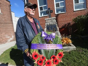 Tom Allen, a Royal Canadian Legion member and the Sgt.-at-Arms at the Baron Byng Legion on Coxwell Ave. and Gerrard St. E., poses with a wreath that will be laid at their monument on Remembrance Day.
