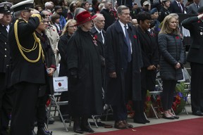 Ontario Lieutenant Governor Elizabeth Dowdeswell and Toronto Mayor John Tory stand at attention during the Remembrance Day ceremony at the Toronto Cenotaph at Old City Hall on Friday, November 11, 2022.
