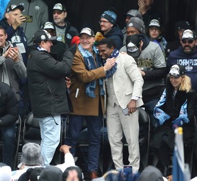Toronto Argonauts general manager Michael (Pinball) Clemons is hugged by team president Bill Manning as the Argos take to the main stage at Maple Leaf Square for a victory rally to celebrate their championship Gray Cup on Thursday, November 24, 2022. JACK BOLAND/TORONTO SOLEIL