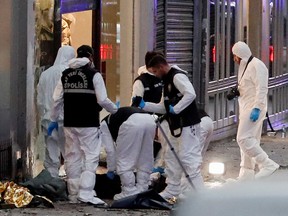 Police members work near the bodies of unidentified people after an explosion on busy pedestrian Istiklal street in Istanbul, Turkey, November 13, 2022.