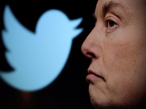 Twitter logo and a photo of Elon Musk are displayed through magnifier in this illustration taken on Oct. 27, 2022.