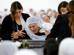 An Israeli Druze woman reacts in front of the body of 17-year-old Tiran Fero, on November 24, 2022, during his funeral ceremony in Daliyat al Karmel.