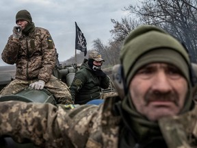 Ukrainian servicemen ride a 2S7 Pion self-propelled gun, as Russia's attack on Ukraine continues, near a frontline in Kherson region, Ukraine, Nov. 9, 2022.