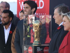 Former Canadian international players Dwayne de Rosario (left), Stephane Labbe and Brazilian superstar Kaka help Toronto Mayor John Tory and Mississauga Mayor Bonnie Crombie (right) unveil the World Cup trophy at Pearson international airport on Wednesday, Nov. 9, 2022.