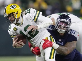 Green Bay Packers quarterback Aaron Rodgers (12) is sacked by Tennessee Titans defensive tackle Jeffery Simmons.