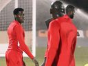 Canada striker Jonathan David (C) looks on during a training session at Umm Slal SC's training facilities in Doha on November 20, 2022, during the FIFA World Cup Qatar 2022. 
