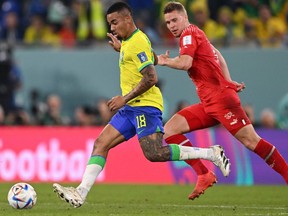 Brazil's forward #18 Gabriel Jesus (L) and Switzerland's defender #04 Nico Elvedi fight for the ball during the Qatar 2022 World Cup Group G football match between Brazil and Switzerland at Stadium 974 in Doha on November 28, 2022.