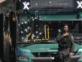 Israeli police inspect the scene of an explosion at a bus stop in Jerusalem, Nov. 23, 2022.