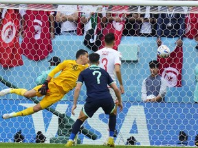 Tunisia's goalkeeper Aymen Dahmen fails to stop the ball as Australia's Mitchell Duke scores the opening goal of his team during the World Cup group D soccer match between Tunisia and Australia at the Al Janoub Stadium in Al Wakrah, Qatar, Nov. 26, 2022.