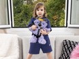 Balenciaga campaign featuring child holding teddy bear wearing BDSM harnesses.