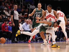 Scottie Barnes of the Raptors knocks the ball away from Jaden Ivey of the Pistons during the first half at Little Caesars Arena in Detroit on Monday, Nov. 14, 2022.