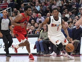 Miami Heat guard Kyle Lowry drives to the net against Toronto Raptors forward Thaddeus Young during the first half at Scotiabank Arena.