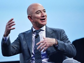 In this file photo taken on Oct. 22, 2019 Blue Origin founder Jeff Bezos speaks after receiving the 2019 International Astronautical Federation (IAF) Excellence in Industry Award during the the 70th International Astronautical Congress at the Walter E. Washington Convention Center in Washington, D.C.