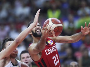 Canada's Phil Scrubb reaches for the ball during a Group H match against Lithuania for the FIBA Basketball World Cup 2019 in Dongguan in south China's Guangdong province on Tuesday, Sep. 3, 2019.