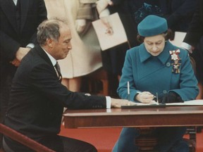 Prime Minister Pierre Elliott Trudeau and Queen Elizabeth II sign the Constitution in Ottawa on April 17, 1982.