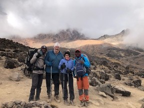 Dennis Robinson and Betty Motton, with their guides, during their recent trek up Mount Kilimanjaro to raise funds for children's cancer research and to honour their six-year-old grandson, a cancer survivor