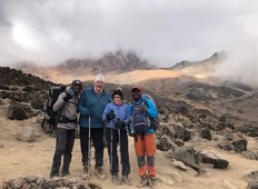 Dennis Robinson and Betty Motton, with their guides, during their recent trek up Mount Kilimanjaro to raise funds for children's cancer research and to honour their six-year-old grandson, a cancer survivor