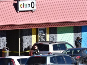 Law enforcement officers document evidence in the parking lot the morning after a mass shooting at Club Q, an LGBTQ nightclub in Colorado Springs, Colorado, on Nov. 20, 2022.
