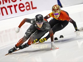 Canada's Rikki Doak takes a corner ahead of a Chinese competitor during short track speed skating World Cup action in Montreal last month.