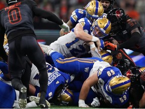 Winnipeg Blue Bombers quarterback Dakota Prukop pushes ahead for a first down during the first half of CFL football game against the B.C. Lions in Vancouver, on Saturday, October 15, 2022.