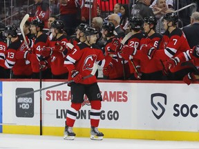 New Jersey Devils defenseman Dougie Hamilton (7) celebrates with teammates after scoring a goal against the Calgary Flames during the second period of an NHL hockey game, Tuesday, Nov. 8, 2022, in Newark, N.J.
