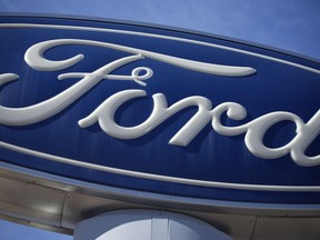 This Oct. 24, 2021 file photo shows a Ford logo on a sign at a dealership in southeast Denver.