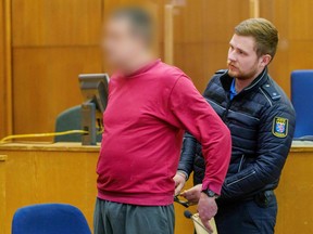 Handcuffs are taken off the defendant and alleged author of "NSU 2.0" threatening letters ahead of the continuation of his trial in Frankfurt am Main, Germany on November 17, 2022.