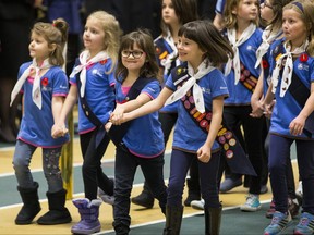 In this file photo taken on Nov. 11, 2015, Girl Guides march during the 2015 City of Edmonton Remembrance Day service at the University of Alberta Butterdome in Edmonton.