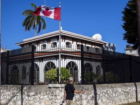 A man walks beside Canada's embassy in Havana, Cuba, Tuesday, April 17, 2018.