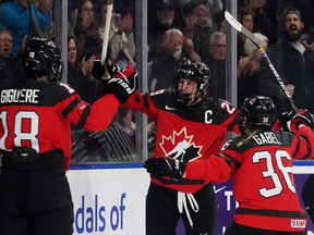 Canada's Marie-Philip Poulin (29) celebrates her goal against the United States with teammates Elizabeth Giguere (18) and Loren Gabel (36) during second period Rivalry Series hockey action in Kelowna, B.C., Tuesday, Nov. 15, 2022.