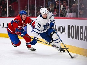Montreal Canadiens center Christian Dvorak chases Toronto Maple Leafs right wing Mitch Marner along the boards during the first period at Bell Centre.