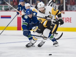 Vancouver Canucks forward Nils Aman (88) stick checks Pittsburgh Penguins defenseman Kris Letang (58) in the first period at Rogers Arena.