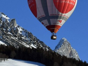 A hot-air balloons is pictured over the village of Filzmoos in the Dachstein mountains, Austria, Jan. 12, 2020.