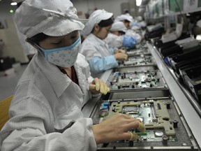 This file photo taken on May 27, 2010 shows Chinese workers at the Foxconn factory in Shenzhen, south China's Guangdong province.
