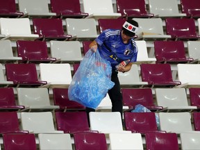 A Japanese fan clears rubbish from the stands during the FIFA World Cup Qatar 2022 Group E match between Germany and Japan at Khalifa International Stadium on Nov. 23, 2022 in Doha, Qatar.