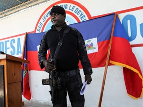 Former police officer Jimmy "Barbecue" Cherizier, leader of the G9 coalition, stands during a news conference announcing that the blockade of fuel terminals will be temporarily lifted to allow for gasoline distribution after weeks of crippling shortages, in Port-au-Prince, Haiti Nov. 12, 2021.