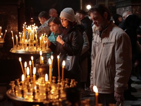 People visit St Volodymyr’s Cathedral during the Sunday service on November 20, 2022 in Kyiv, Ukraine.