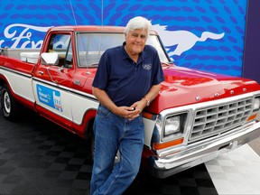 U.S. comedian Jay Leno poses in front of a 1979 Ford F-150 pickup, in the style of one owned by Walmart founder Sam Walton, on Aug. 20, 2022, during the 27th annual Woodward Dream Cruise, in Royal Oak, Mich.